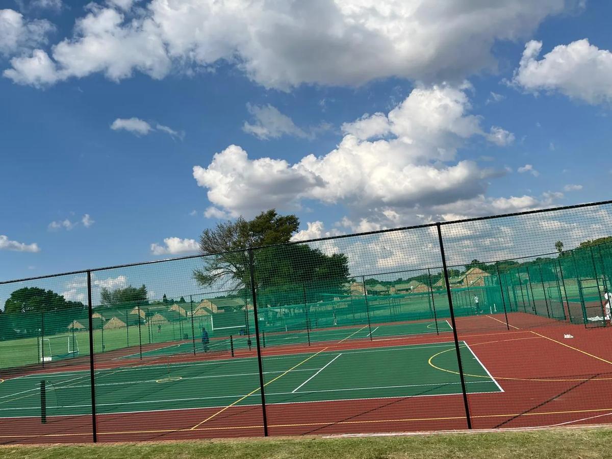 Green acrylic courts with full perimeter fencing